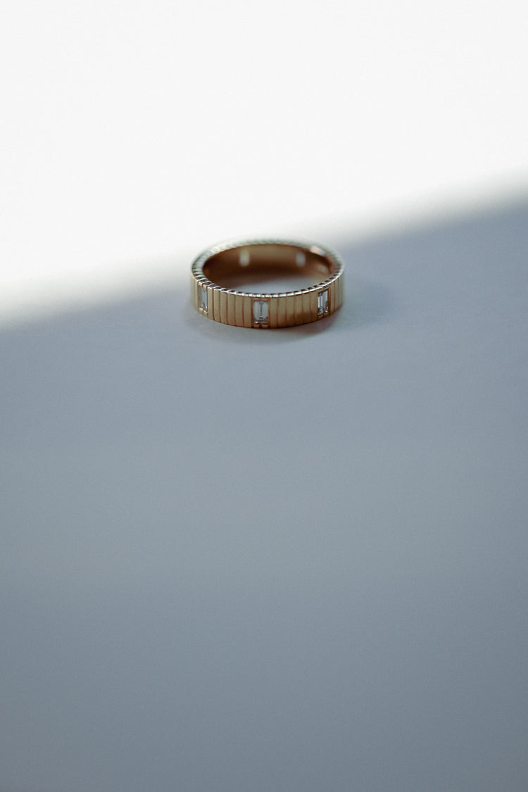Ring with a geometric design on a gray surface
