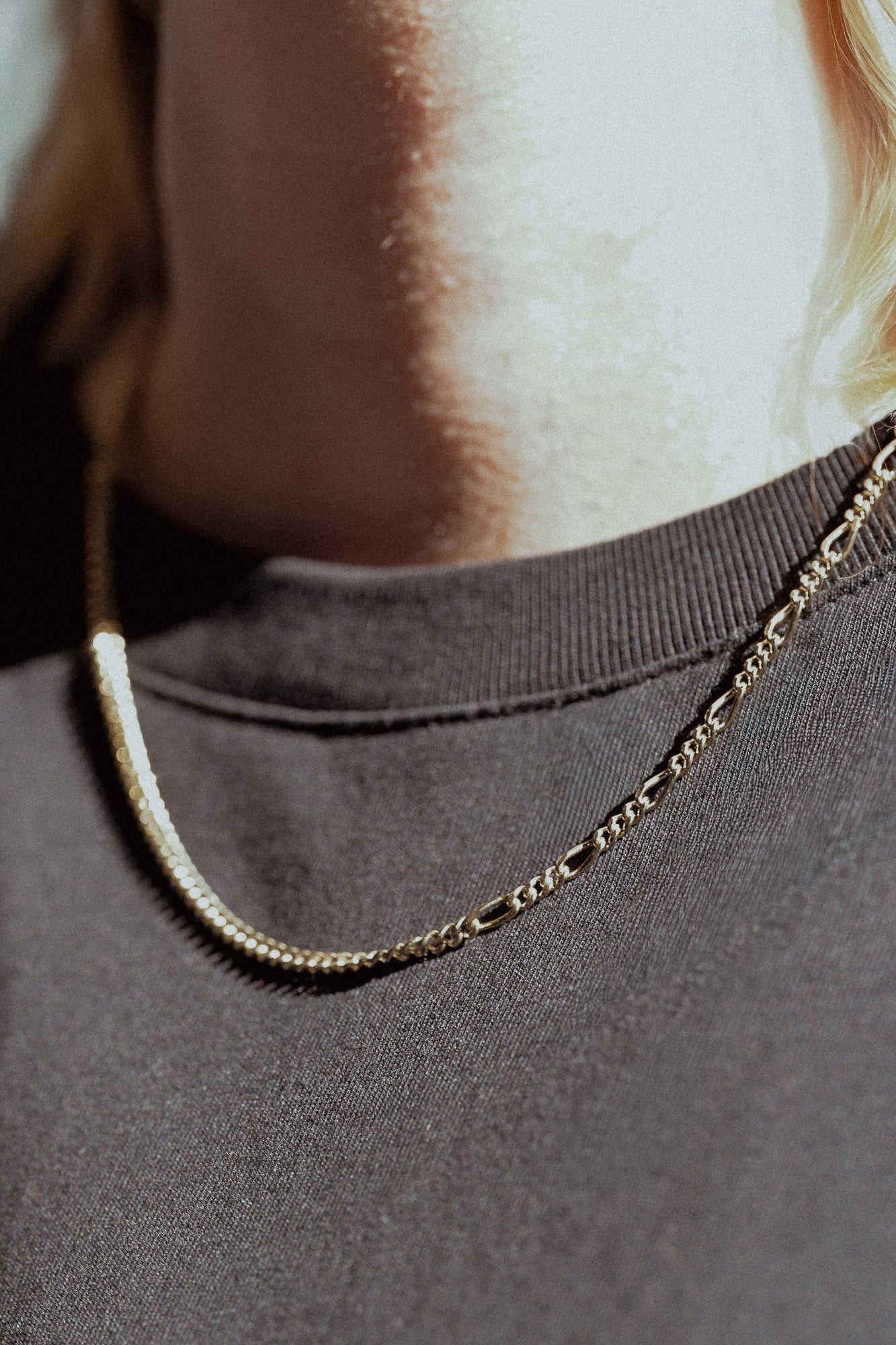 Close up of a chain necklace on a person wearing the unique design
