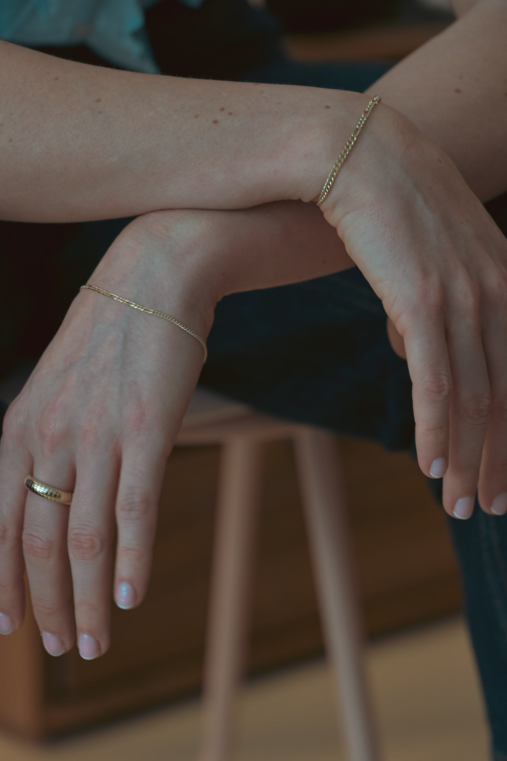 Lady wearing the cove band gender neutral jewellery gold ring.